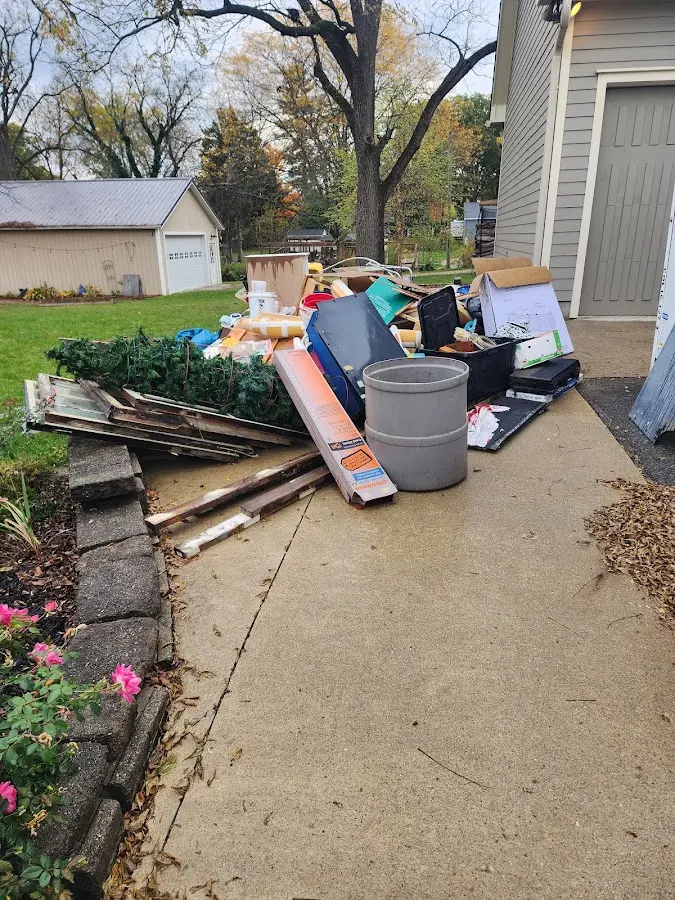 Dumpster being loaded with debris for 12 Yard Dumpster Rental in Opelousas